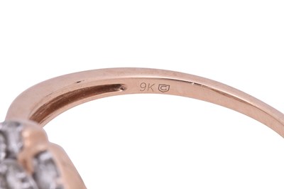 Lot 8 - A DIAMOND-SET ROSE GOLD HALO RING