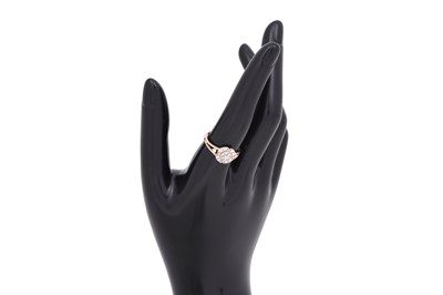 Lot 8 - A DIAMOND-SET ROSE GOLD HALO RING