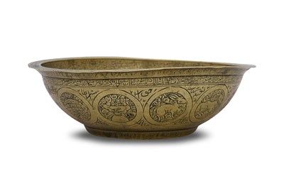 Lot 378 - A QAJAR-STYLE ENGRAVED BRASS ‘MAGIC’ BOWL WITH ZODIAC SIGNS