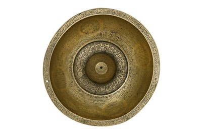 Lot 38 - A QAJAR-STYLE ENGRAVED BRASS ‘MAGIC’ BOWL WITH ZODIAC SIGNS