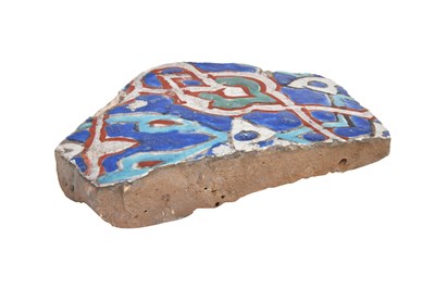 Lot 148 - A POLYCHROME CUERDA SECA POTTERY TILE FRAGMENT
