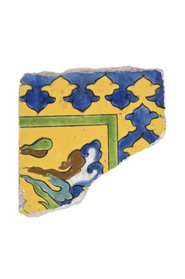 Lot 350 - A SAFAVID CUERDA SECA POTTERY TILE FRAGMENT WITH CHINESE 'RU' CLOUD