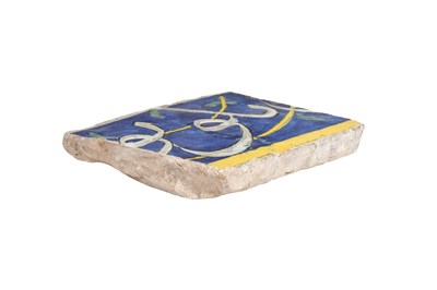 Lot 349 - A FRAGMENTARY SAFAVID CUERDA SECA CALLIGRAPHIC POTTERY TILE