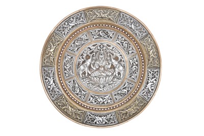 Lot 332 - A COPPER AND SILVER-OVERLAID TANJORE BRASS PLATE WITH GAJA LAKSHMI