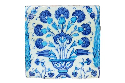 Lot AN IZNIK POTTERY TILE WITH A FLOWER VASE