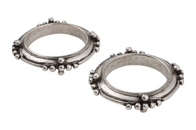 Lot 11 - A PAIR OF WESTERN SAHARAN SILVER BANGLES (DEBLIĞ) WITH APPLIED SPHERES AND WIRE