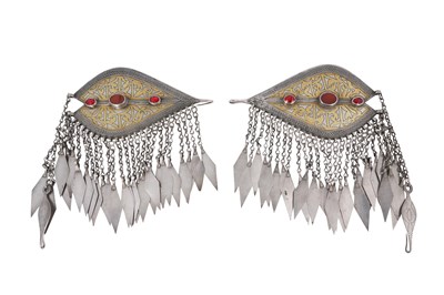Lot 94 - A PAIR OF SIGNED TURKMEN TEKKE TRIBE CARNELIAN-SET PARCEL-GILT SILVER DRESS ORNAMENTS