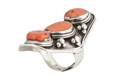 Lot 126 - A TIBETAN KHAMPA CORAL-SET MALE 'SADDLE' SILVER RING
