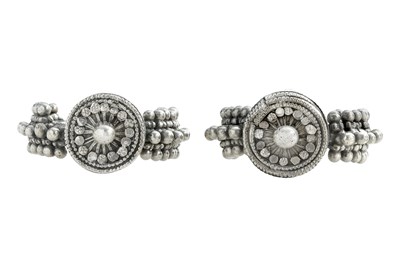 Lot 52 - A PAIR OF OMANI SILVER ARMLETS WITH DISC AND SPHERES