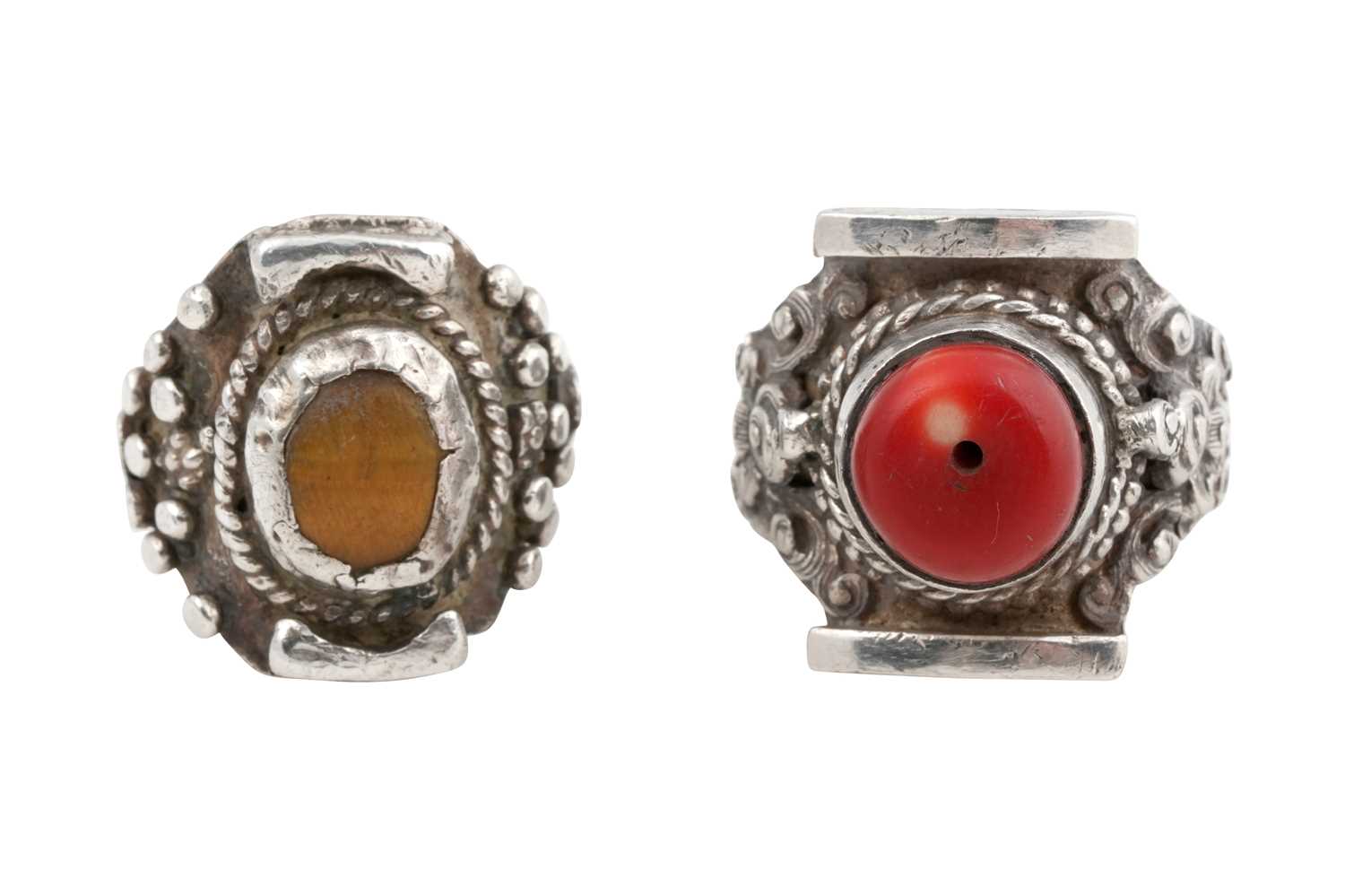 Lot 128 - TWO TIBETAN 'SADDLE' SILVER RINGS (TAGAM)