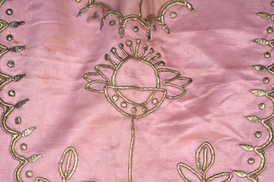 Lot 82 - AN IRAQI CUSTOM-MADE PINK SATIN SILK BRIDAL DRESS AND SQUARE COVER