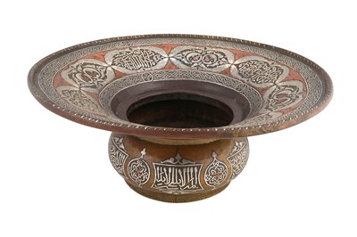 Lot 199 - A DAMASCUS-WARE SILVER AND COPPER-INLAID COPPER BASIN WITH PAIRS OF FISH AND CALLIGRAPHY