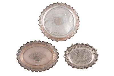 Lot 201 - THREE MALAY ENGRAVED AND CHASED SILVER ALLOY SERVING TRAYS