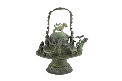Lot 198 - A LARGE BRONZE MALAY BORNEO RITUAL KETTLE WITH ANIMALS AND GUARDIAN FIGURES