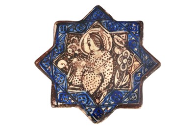 Lot 101 - AN ILKHANID COBALT BLUE AND COPPER LUSTRE-PAINTED STAR-SHAPED FIGURAL POTTERY TILE