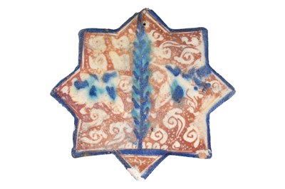 Lot 100 - AN ILKHANID COBALT BLUE, TURQUOISE AND COPPER LUSTRE-PAINTED STAR-SHAPED POTTERY TILE