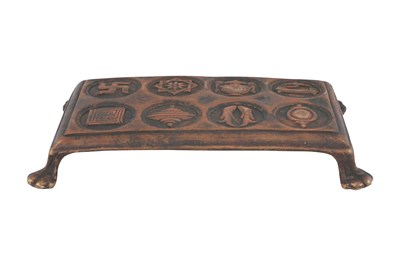 Lot 121 - A BUDDHIST CAST BRONZE RITUAL STAND WITH THE ASHTAMANGALA (EIGHT AUSPICIOUS SYMBOLS)