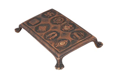 Lot 121 - A BUDDHIST CAST BRONZE RITUAL STAND WITH THE ASHTAMANGALA (EIGHT AUSPICIOUS SYMBOLS)