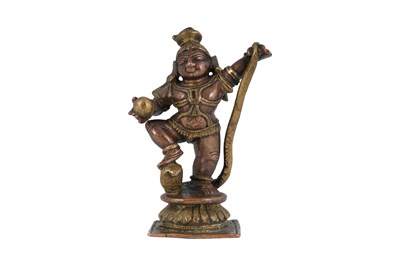 Lot 179 - A MINIATURE COPPER AND BRASS FIGURINE OF KRISHNA DANCING ON THE SNAKE KALIYA