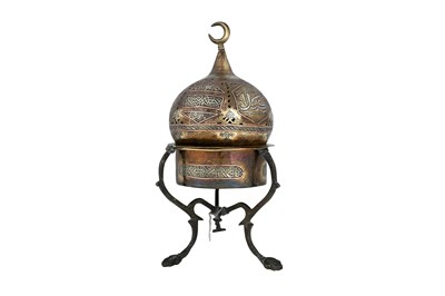 Lot 40 - A MAMLUK-REVIVAL CAIROWARE COPPER AND SILVER-INLAID OPENWORK BRASS INCENSE BURNER WITH STAND