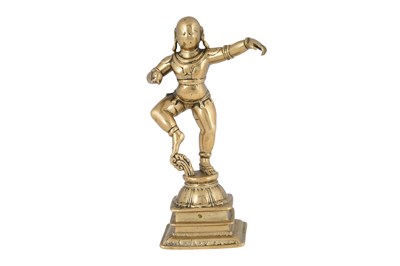 Lot 129 - A BRASS FIGURINE OF KRISHNA DANCING ON A LOTUS PEDESTAL