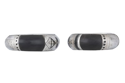 Lot 7 - A NEAR PAIR OF SIGNED TUAREG DARK WOOD AND SILVER BANGLES