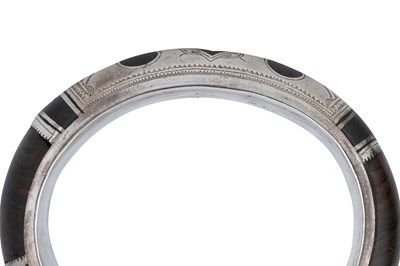 Lot 7 - A NEAR PAIR OF SIGNED TUAREG DARK WOOD AND SILVER BANGLES