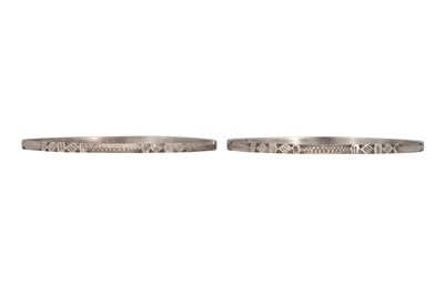 Lot 24 - SEVEN INCISED SILVER BANGLES WITH GEOMETRIC MOTIFS