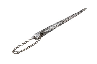 Lot 87 - A CHASED AND INCISED WHITE METAL GARMENT TOGGLE