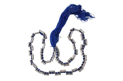 Lot 3 - AN ETHIOPIAN INDIGO BLUE STRING NECKLACE WITH SILVER COIL AMULETS