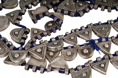 Lot 2 - AN ETHIOPIAN INDIGO BLUE STRING NECKLACE WITH SILVER GEOMETRIC AMULETS