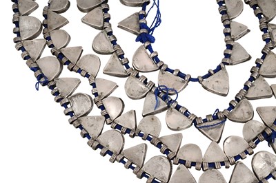 Lot 2 - AN ETHIOPIAN INDIGO BLUE STRING NECKLACE WITH SILVER GEOMETRIC AMULETS