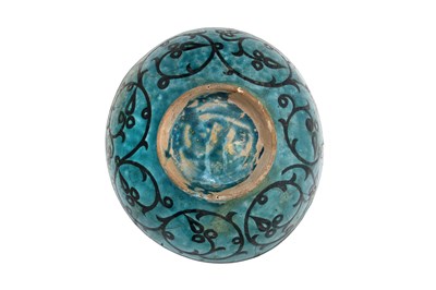 Lot 258 - A BLACK-PAINTED TURQUOISE-GLAZED SELJUK KASHAN-REVIVAL POTTERY DISH WITH COURTLY COUPLE