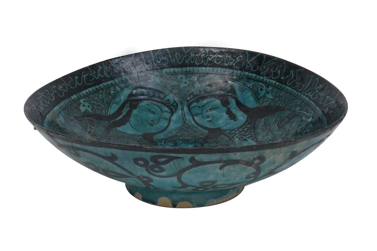 Lot 258 - A BLACK-PAINTED TURQUOISE-GLAZED SELJUK KASHAN-REVIVAL POTTERY DISH WITH COURTLY COUPLE