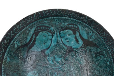 Lot 258 - A BLACK-PAINTED TURQUOISE-GLAZED SELJUK KASHAN-REVIVAL POTTERY DISH WITH COURTLY COUPLE