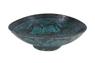 Lot 258 - A BLACK-PAINTED TURQUOISE-GLAZED SELJUK KASHAN-REVIVAL POTTERY DISH WITH COURTLY COUPLE