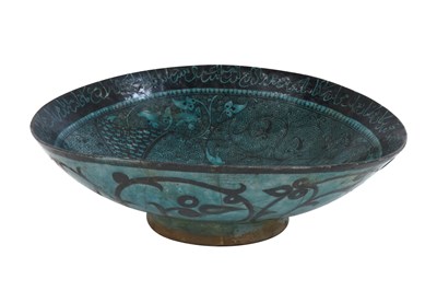 Lot 258 - A BLACK-PAINTED TURQUOISE-GLAZED SELJUK KASHAN-REVIVAL POTTERY DISH WITH COURTLY COUPLE