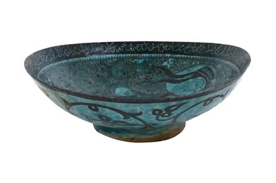 Lot 258 - A BLACK-PAINTED TURQUOISE-GLAZED SELJUK KASHAN-REVIVAL POTTERY DISH WITH COURTLY COUPLE