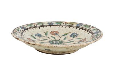 Lot 134 - AN IZNIK POTTERY DISH WITH RED AND BLUE HYACINTHS