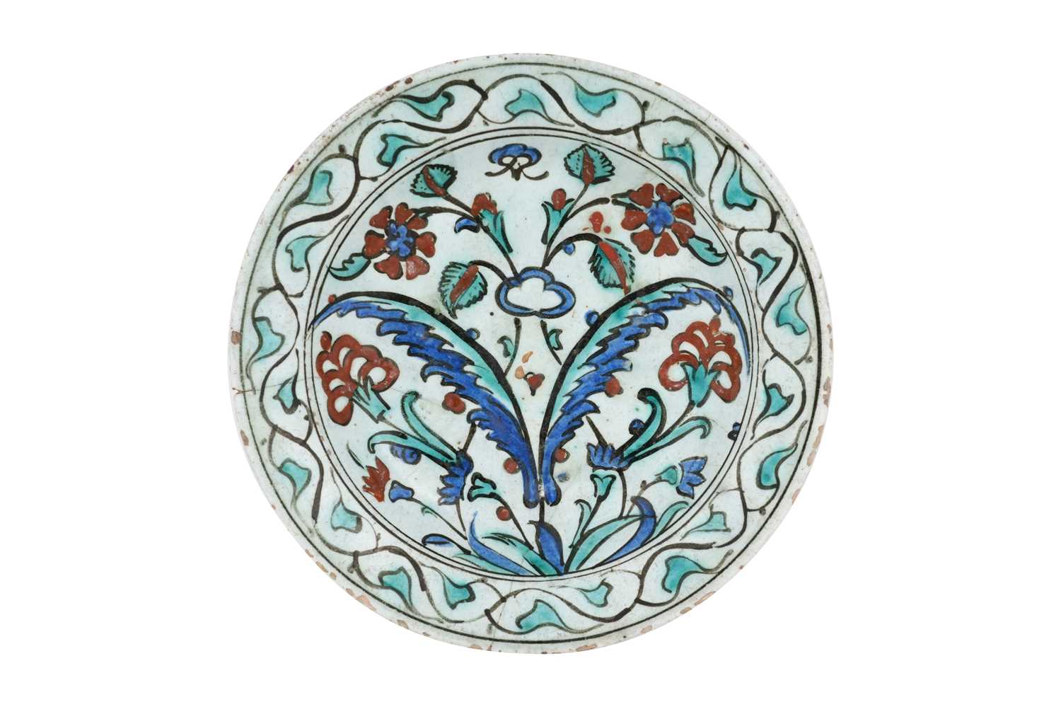 Lot 136 - AN IZNIK POTTERY DISH WITH SAZ LEAVES AND RED ROSETTES
