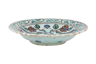 Lot 136 - AN IZNIK POTTERY DISH WITH SAZ LEAVES AND RED ROSETTES
