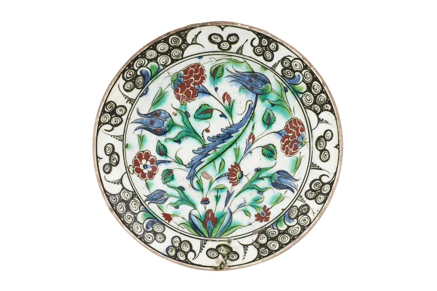 Lot 135 - AN IZNIK POTTERY DISH WITH SAZ LEAF AND FLORAL TRIUMPH