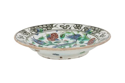 Lot 135 - AN IZNIK POTTERY DISH WITH SAZ LEAF AND FLORAL TRIUMPH