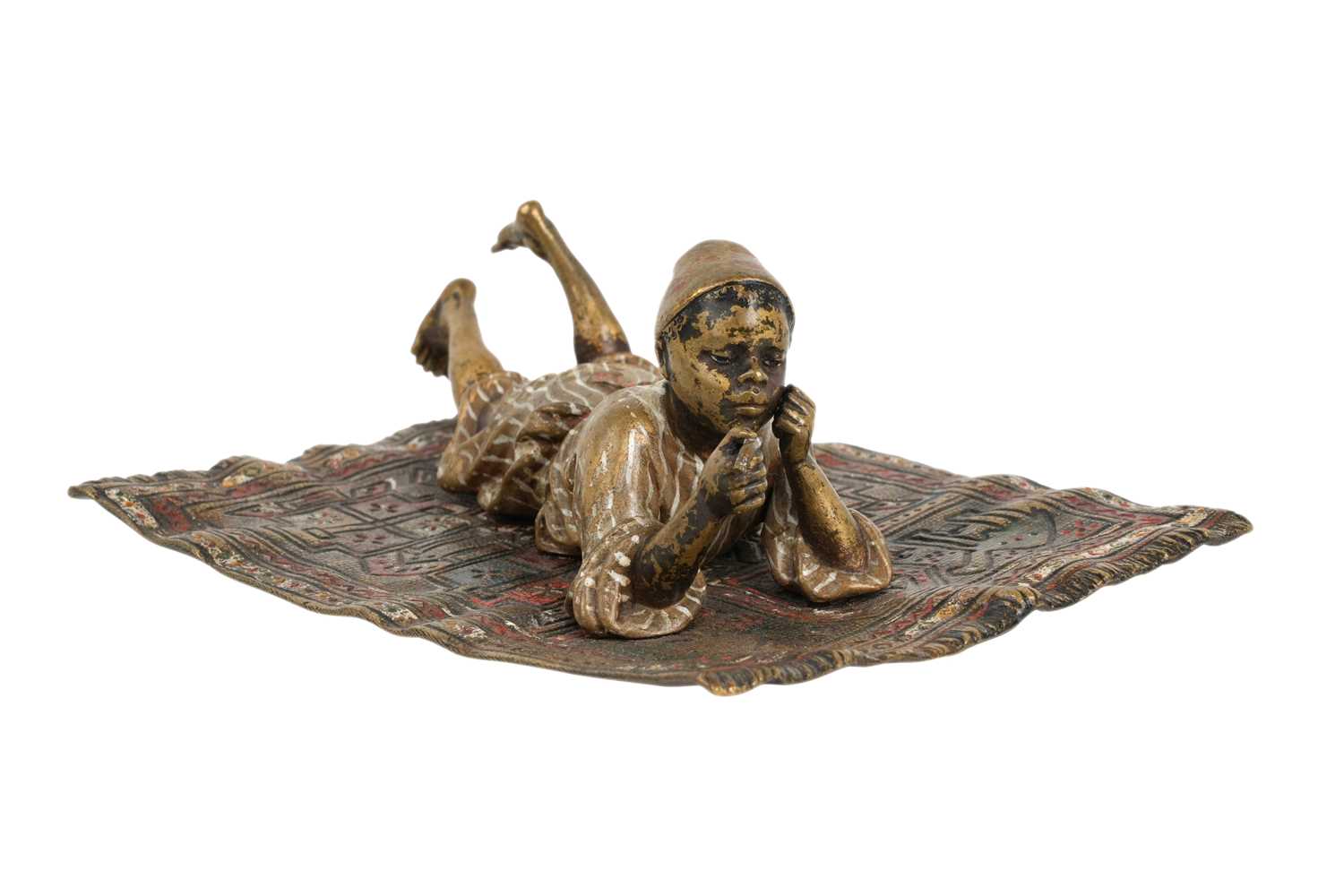 Lot 95 - A COLD-PAINTED BRONZE FIGURE OF A MOORISH BOY ON A CARPET