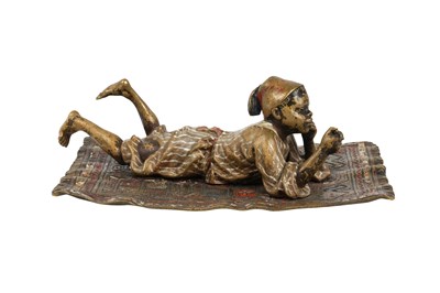 Lot 95 - A COLD-PAINTED BRONZE FIGURE OF A MOORISH BOY ON A CARPET