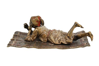 Lot 95 - A COLD-PAINTED BRONZE FIGURE OF A MOORISH BOY ON A CARPET