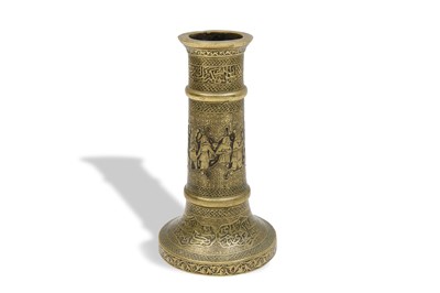 Lot 112 - AN ENGRAVED BRASS SAFAVID-STYLE CANDLESTICK WITH ARCHAISTIC FIGURES