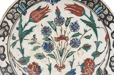 Lot 138 - AN IZNIK POTTERY DISH WITH TULIPS, ROSES AND PLUM BLOSSOMS