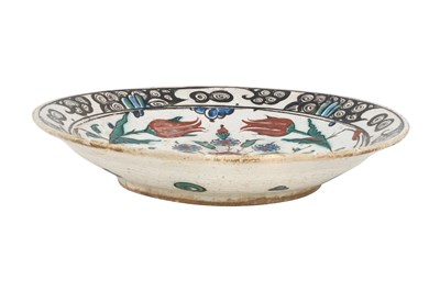 Lot 138 - AN IZNIK POTTERY DISH WITH TULIPS, ROSES AND PLUM BLOSSOMS