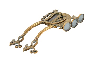 Lot 176 - A LARGE INDIAN BRASS BETEL NUT CRACKER WITH GLASS INLAYS